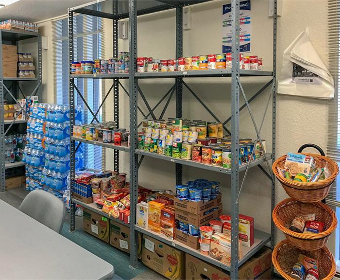 A tall rack is filled with cans and boxes of non-perishable food items